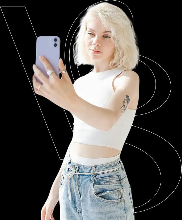 A young woman with blonde hair taking a selfie with a smartphone.